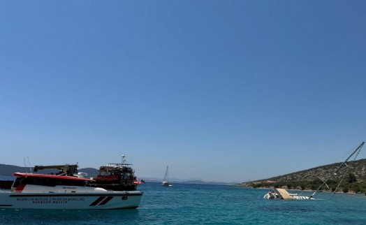 Bodrum'da kayalıklara sürttükten sonra karaya oturan yelkenli için kurtarma çalışması
